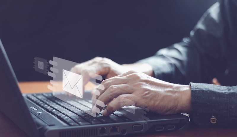 hands on a keyboard sending secure email